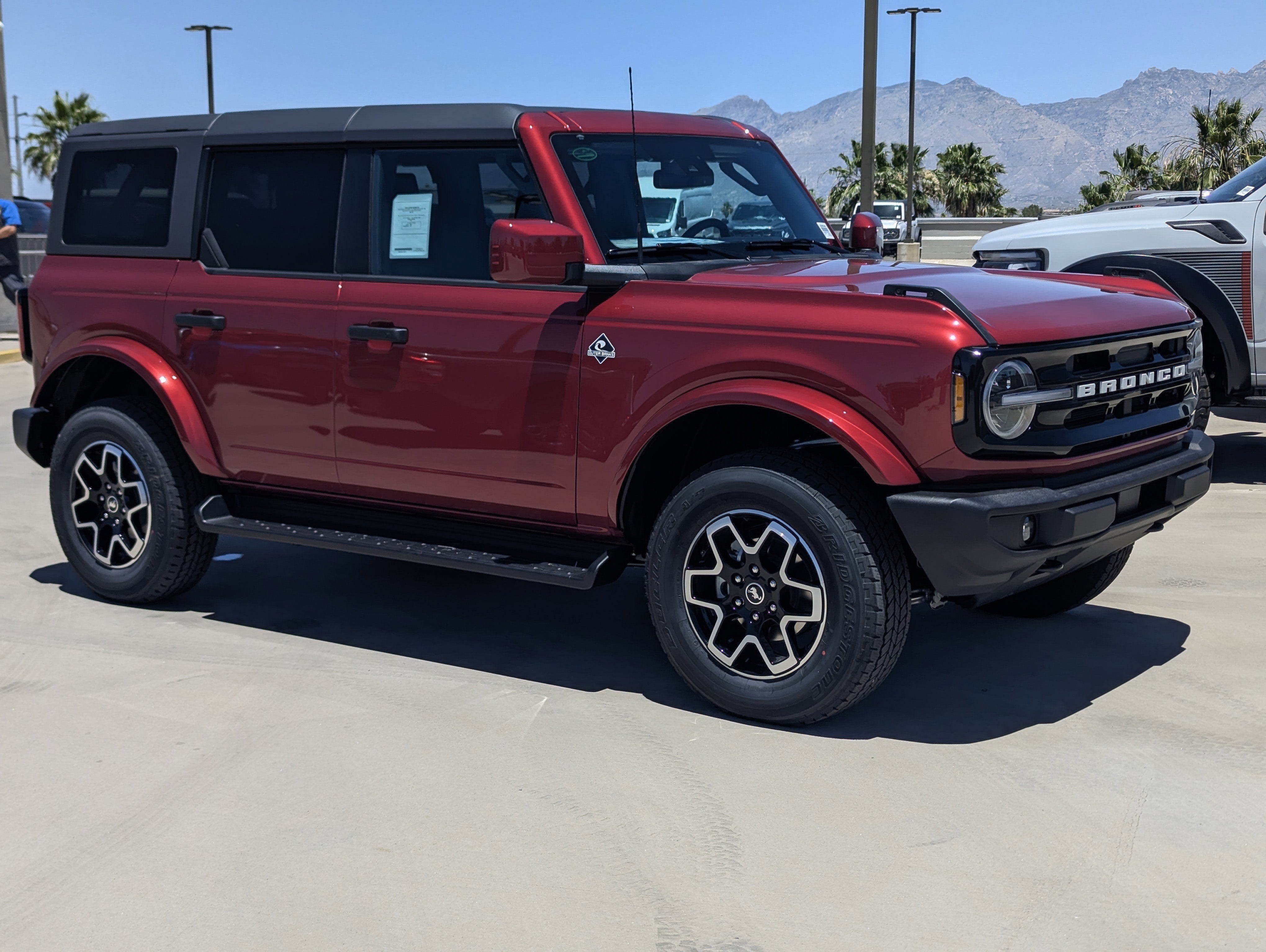2026 Ford Bronco Outer Banks in Ruby Red Metallic Tinted Clearcoat — front three-quarter view