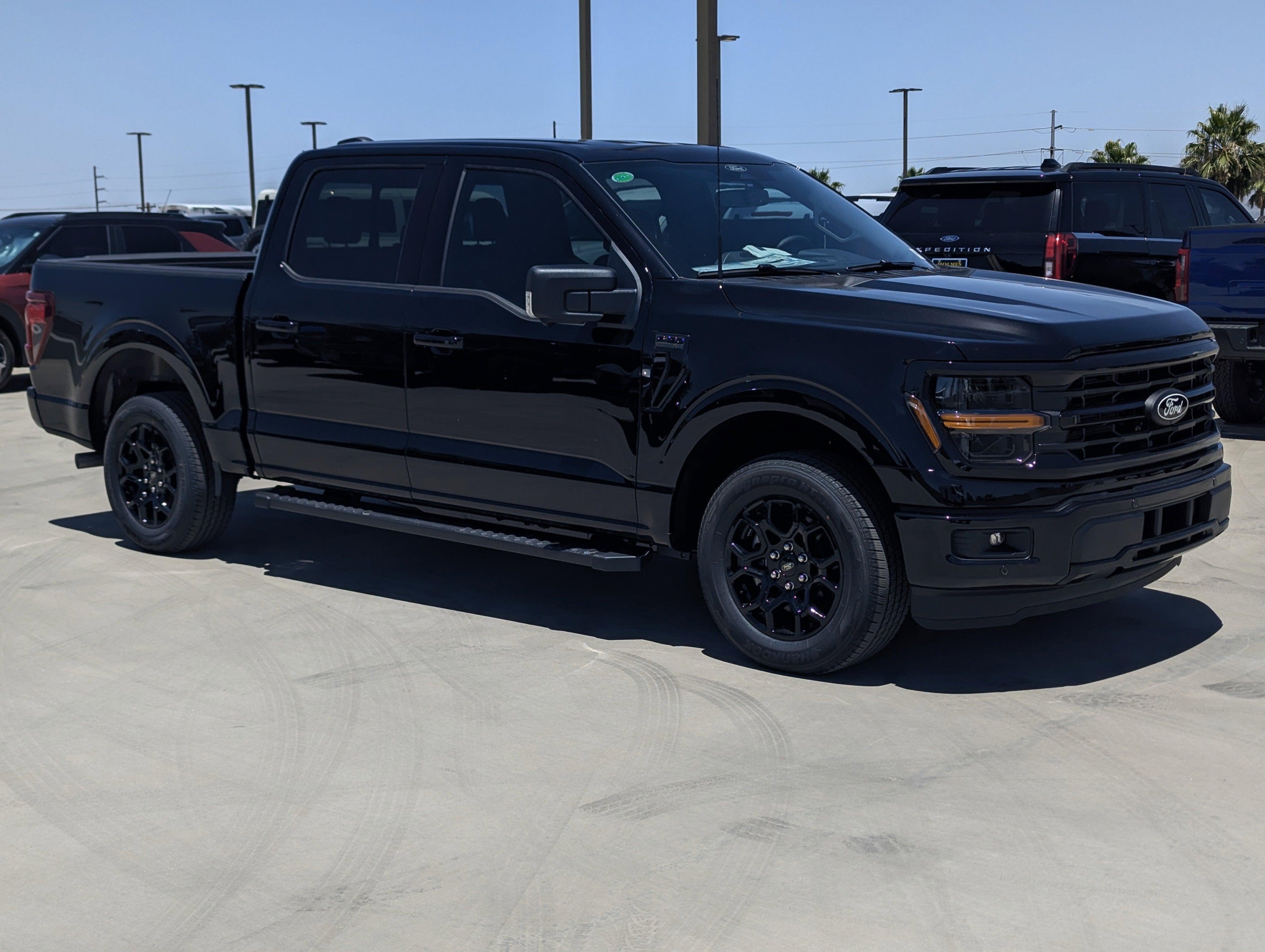 2026 Ford F-150 XLT in Agate Black Metallic — front three-quarter view