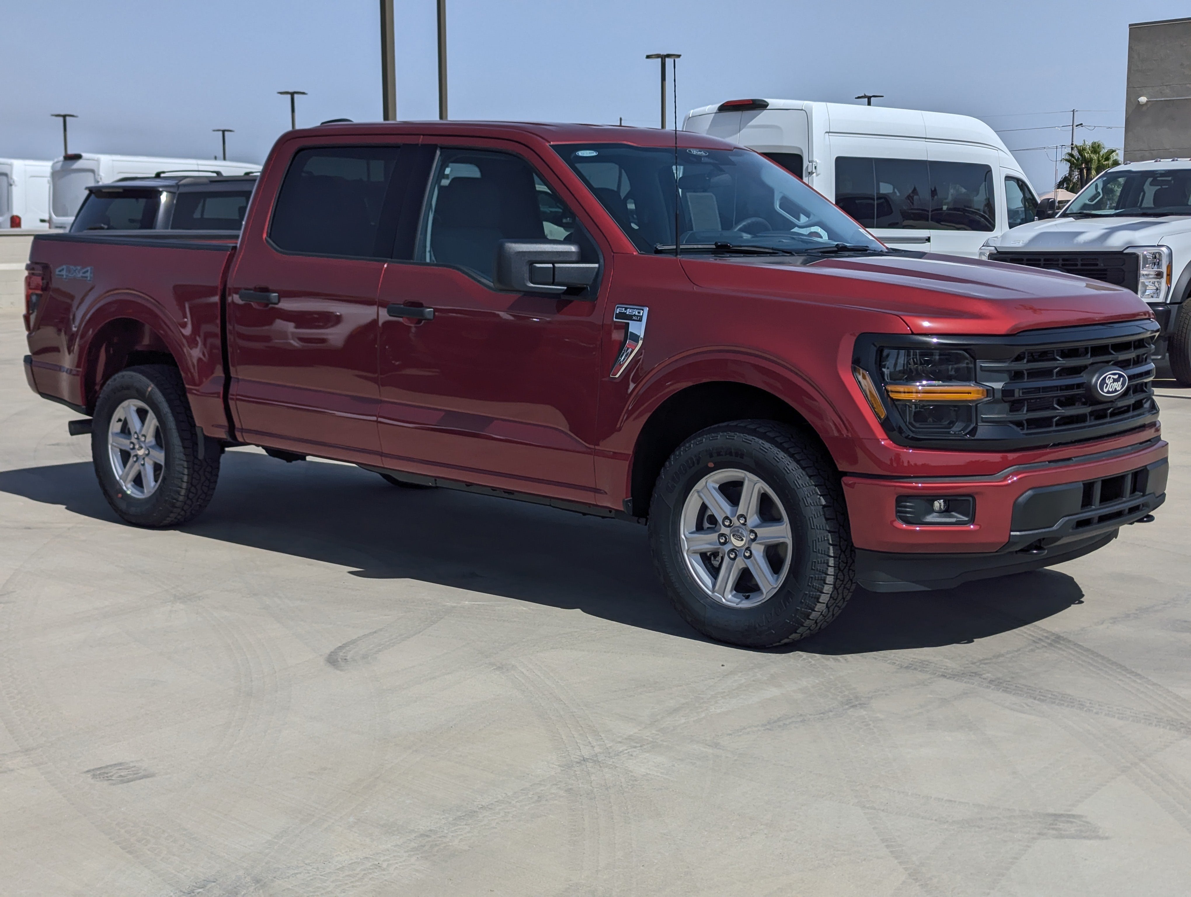 2026 Ford F-150 XLT in Ruby Red Metallic Tinted Clearcoat — front three-quarter view