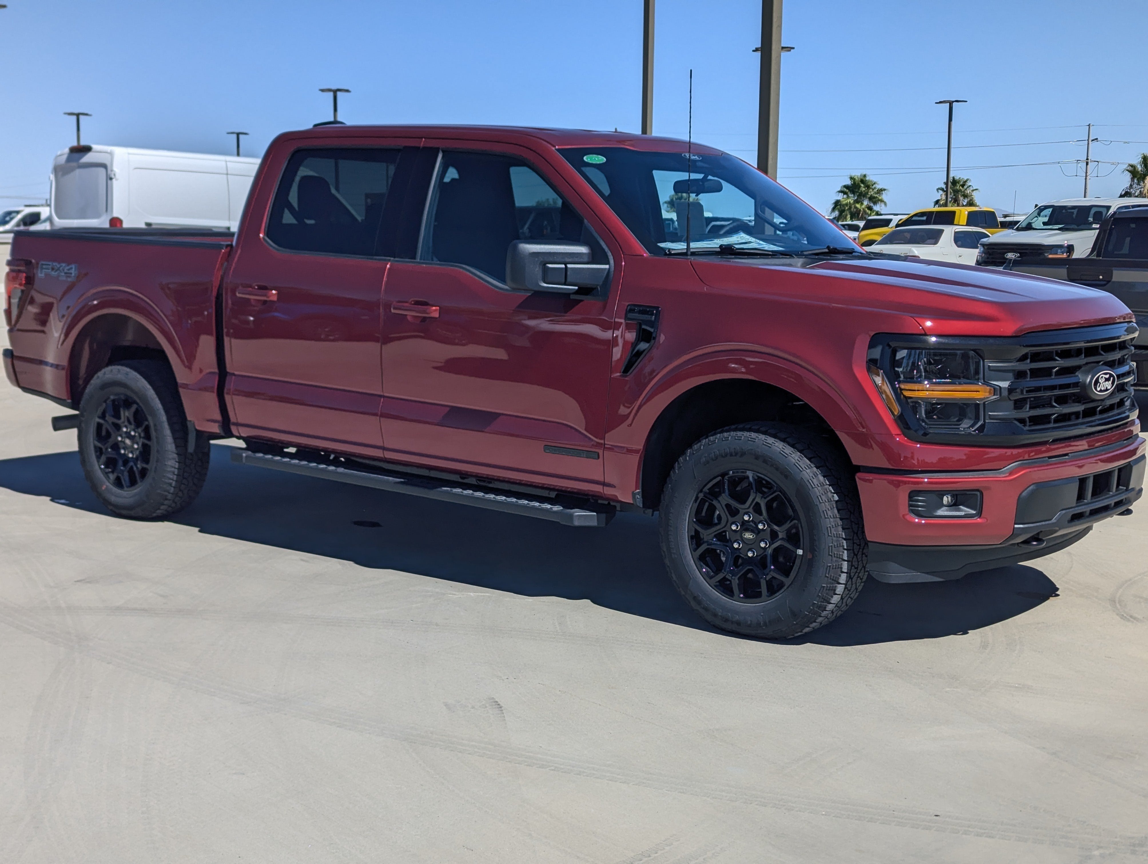 2026 Ford F-150 XLT in Ruby Red Metallic Tinted Clearcoat — front three-quarter view