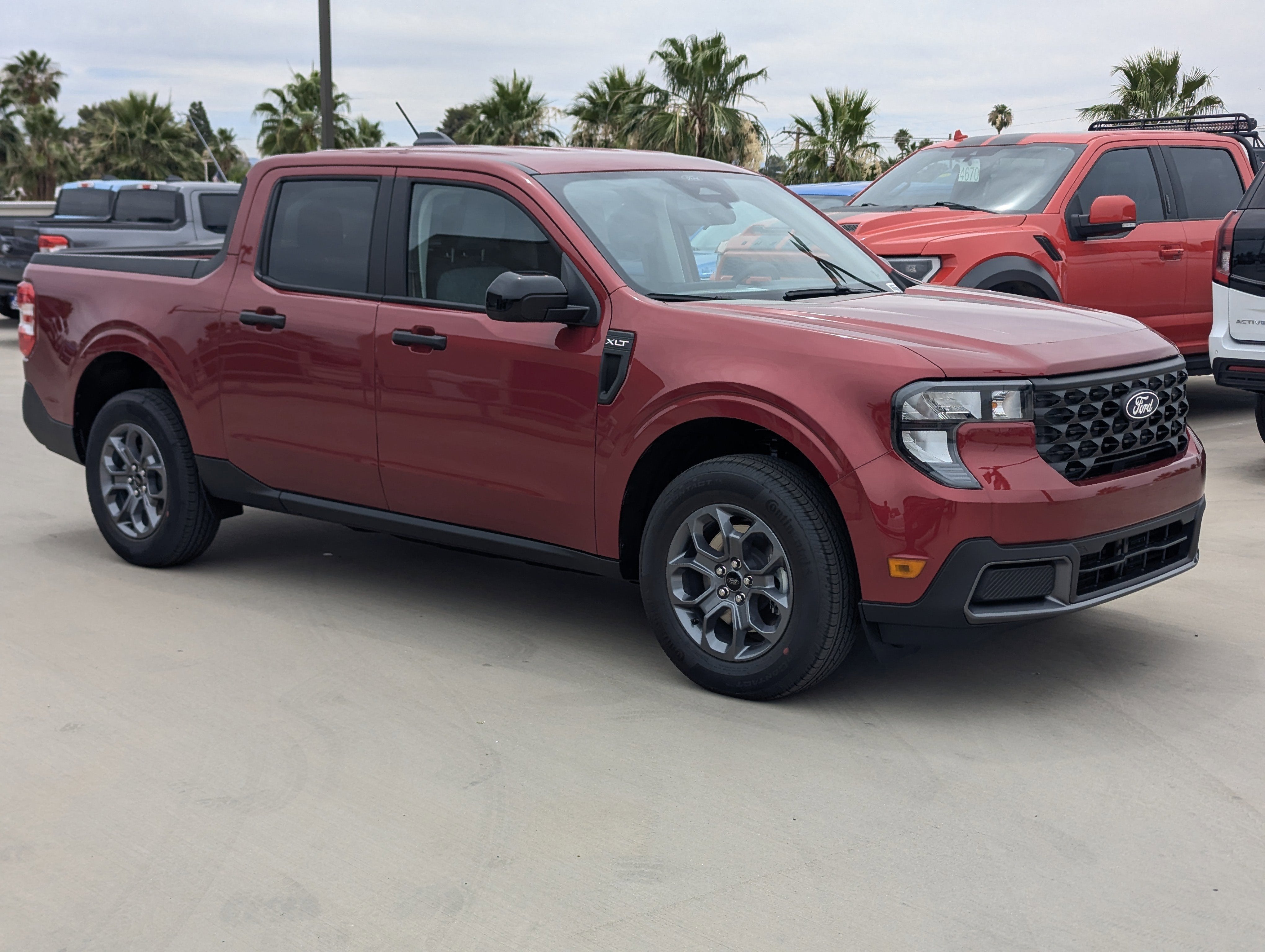 2026 Ford Maverick XLT in Ruby Red Metallic Tinted Clearcoat — front three-quarter view